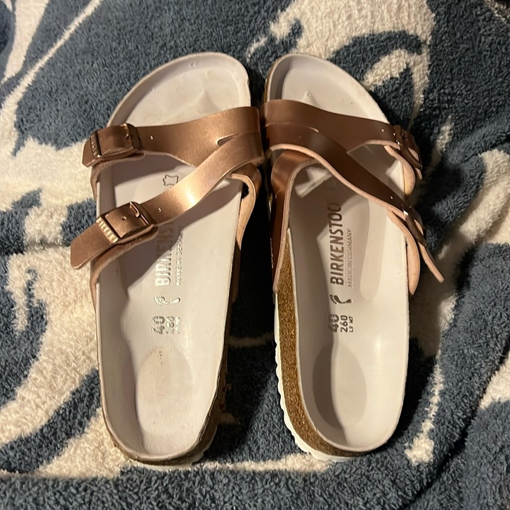 Beautiful rose gold birkenstock sandals. Never been worn!!